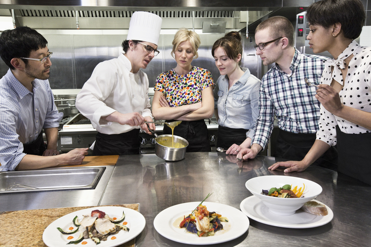 a chef and students at a cookery class in a commer WFXH7PD